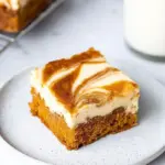 Delicious carrot cake cheesecake bars with cream cheese frosting and spices